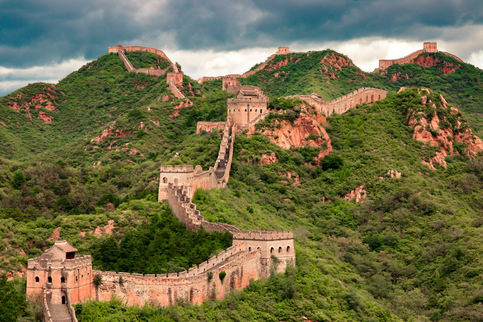 The Great Wall winding over green mountain ridges