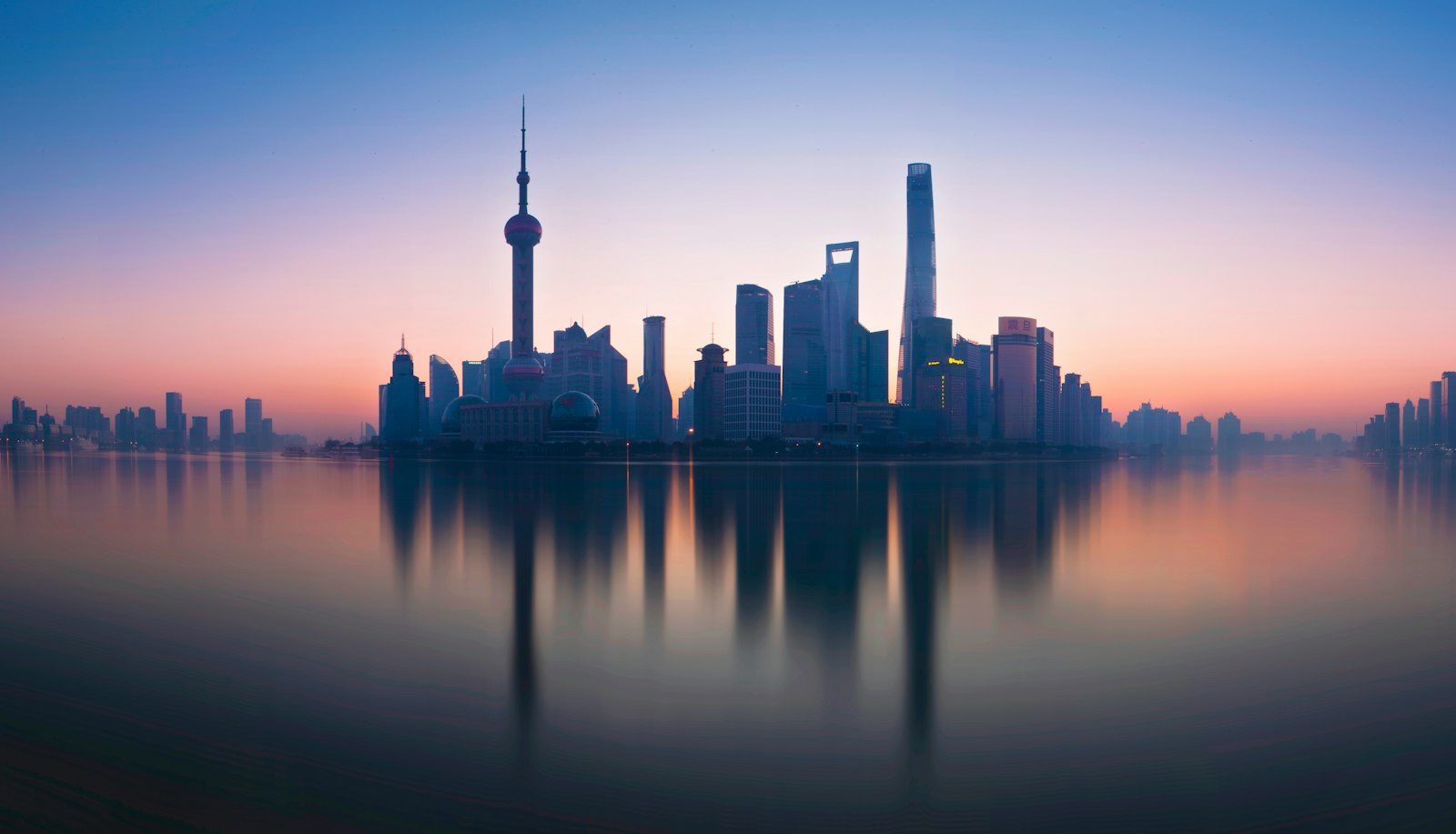 The Shanghai skyline reflected in the Huangpu River at dusk