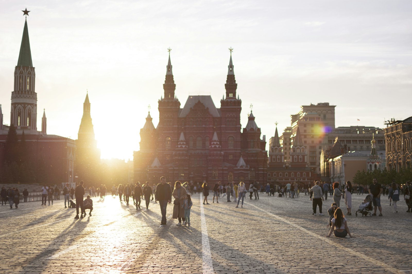 Red Square at sunset, with people walking past the State Historical Museum