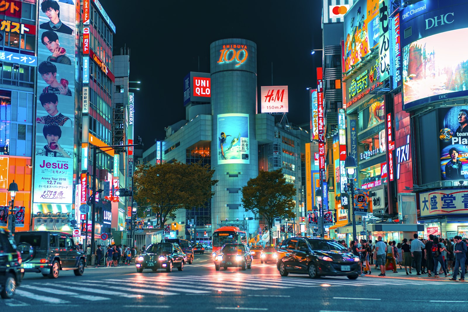 Shibuya Crossing at night under neon signs