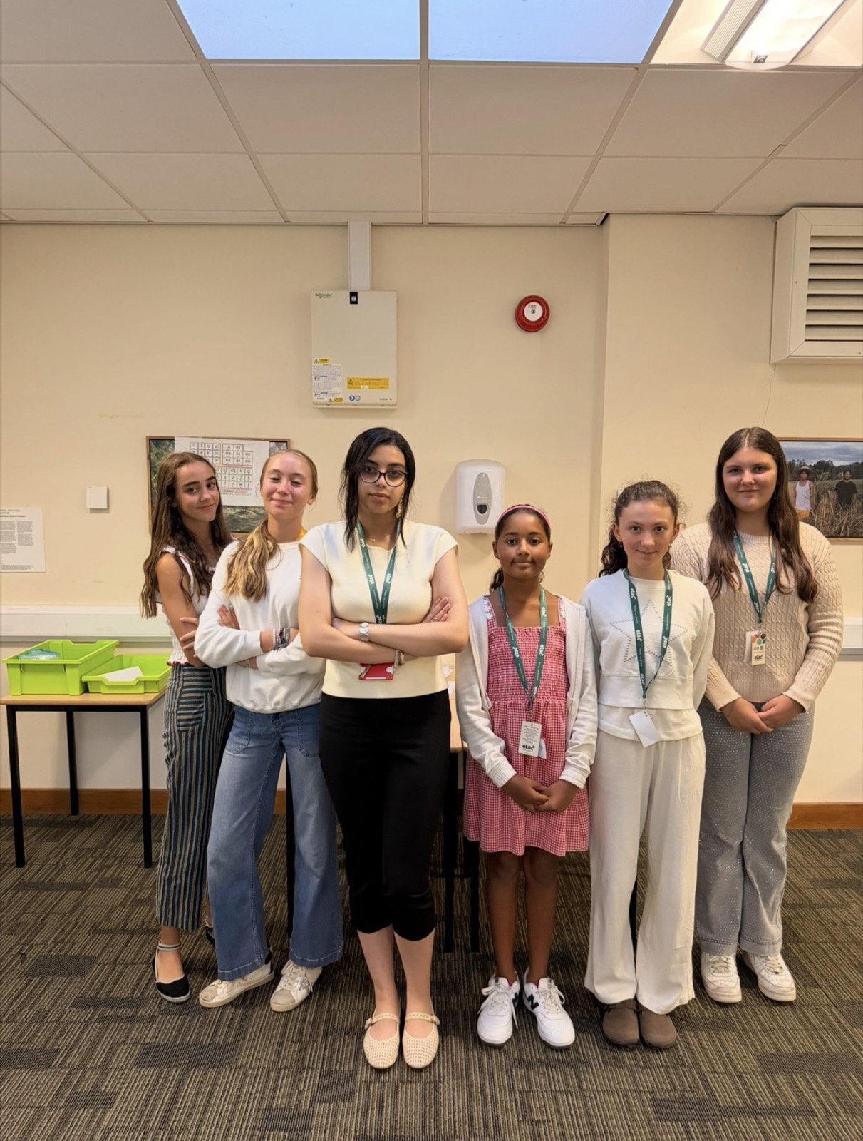 A group of students standing together in a classroom
