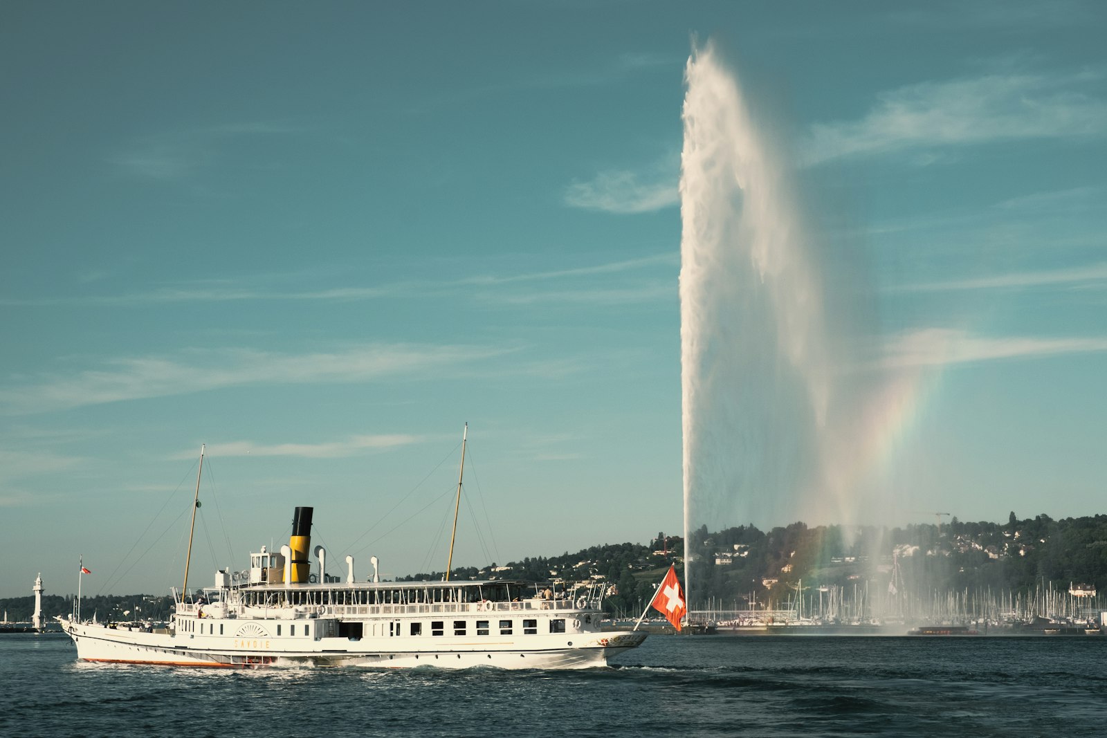 A paddle steamer passing the Jet d'Eau fountain on Lake Geneva